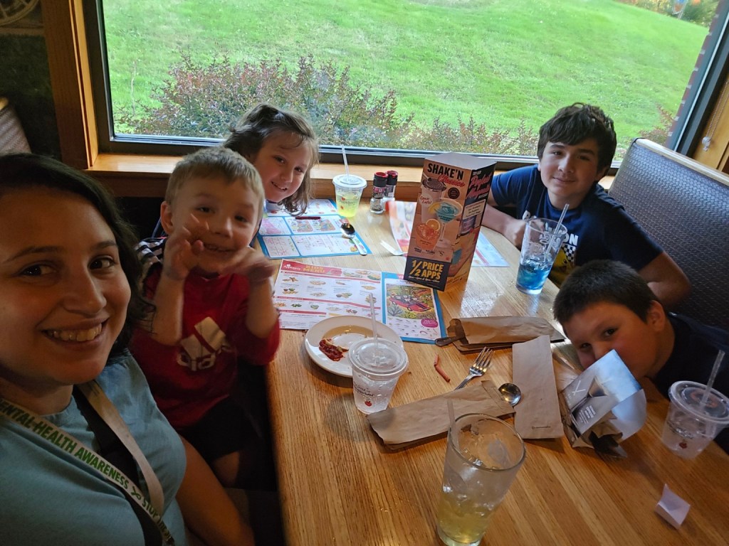 Tashena with her children at a restaurant